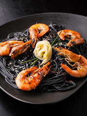 Black spaghetti with shrimps, ginger and sesame seeds