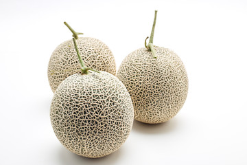 Three cantaloupe melon on white