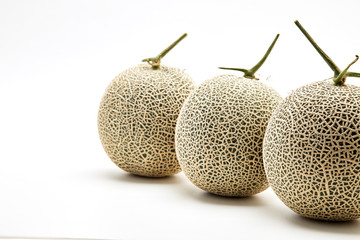 Three cantaloupe melon on white