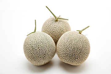 Three cantaloupe melon on white