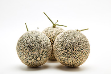 Three cantaloupe melon on white