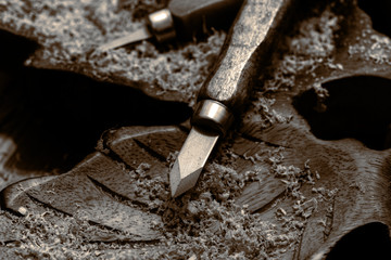 Chisel on a block of carved wood with shavings and sawdust