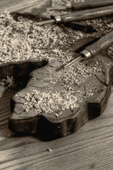 Chisel on a block of carved wood with shavings and sawdust