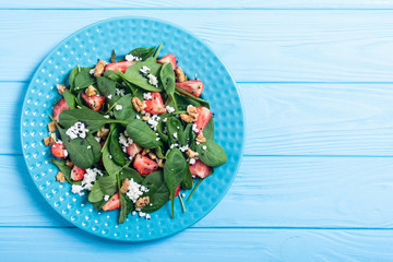 Naklejka premium Strawberry salad with spinach , cheese and walnut