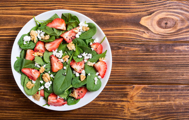 Strawberry salad with spinach , cheese and walnut