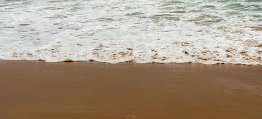 Waves covering the beach sand fulfilling the thirst of sand. Clicked at Goa India.