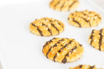Shortbread cookies with nuts and chocolate on a tray