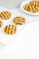 Shortbread cookies with nuts and chocolate on a plate and tray