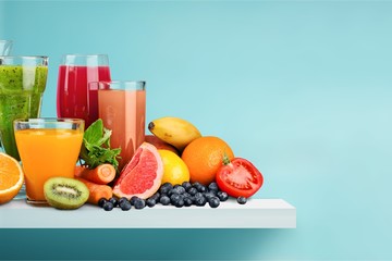 Glasses of fresh juice and fruits on