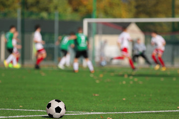 Boys playing a football match and empty space for text