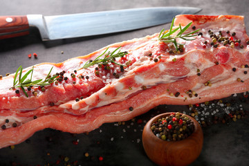 Raw ribs with spices on a stone background