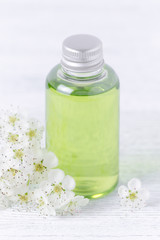 Obraz na płótnie Canvas a shampoo bottle with fresh flowers, selective focus