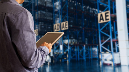 Businessman manager using tablet check and control for workers with Modern Trade warehouse global business commerce concept or import-export commercial logistic. Industry 4.0 concept