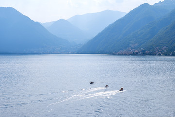 Three boats cruising parallel on water