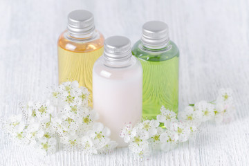Fototapeta na wymiar natural cosmetic bottles with fresh flowers, white, green and yellow