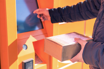 Man putting box to parcel machine