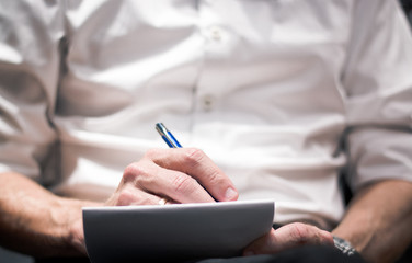 Fototapeta premium businessman writing on his agenda