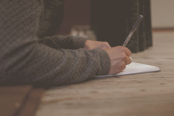 child writing in book