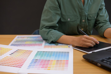 graphic interior designer working with computer. creative man drawing with tablet & stylus pen....