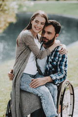 Girl on Wheelchairs with Boyfriend in Summer Park.