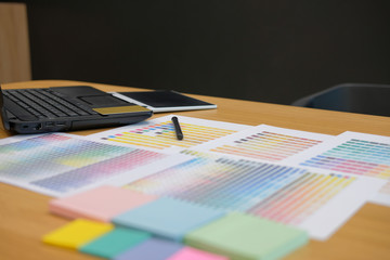 Fototapeta premium color swatch sample catalogue palette guide at graphic designer creative design workplace.
