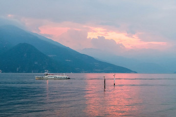 Fototapeta na wymiar Ferry cruising at sunset on Lake Como