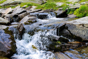Fototapeta premium A small waterfall in the water stream.