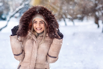 winter holidays, Christmas and people concept – Smiling girl in a white winter forest.