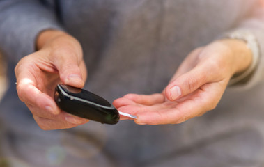 Woman checking blood sugar level 