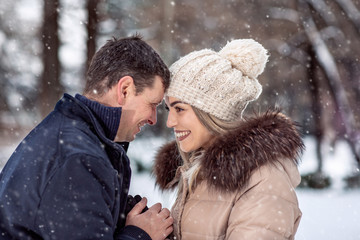 Romantic couple is having fun outdoors in winter.