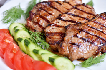 Grilled meat. Restaurant dish. Steak with vegetables.