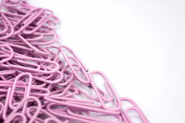 PASTEL PURPLE PAPER CLIPS ON WHITE BACKGROUND WITH COPY SPACE