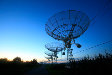 The silhouette of a radio telescope