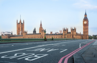 Bus Lane on Westminster Bridge - London, UK - Houses of Parliament and Big Ben tower at dawn. Covid...