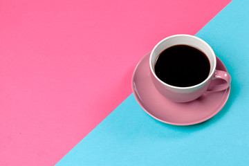 cup of coffee and saucer on color background