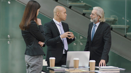 three coporate executives meeting in office