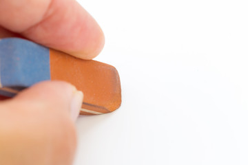 eraser tool in a hand isolated on white background. school and office tool