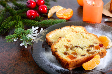 Christmas cake with nuts, dried fruit, tangerines. Traditional festive pastries.