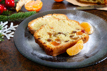 Christmas cake with nuts, dried fruit, tangerines. Traditional festive pastries.