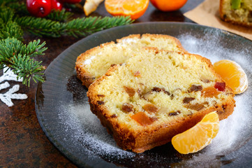 Christmas cake with nuts, dried fruit, tangerines. Traditional festive pastries.