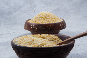 bulgur seeds isolated on texture background