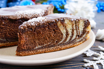 A piece of delicious two-color cake with chocolate and coconut chips. Festive cake.
