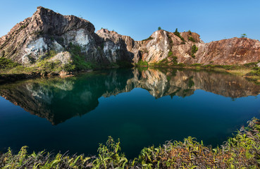 Fototapeta na wymiar Beautiful lake and hill with reflection at an abandoned mining site 