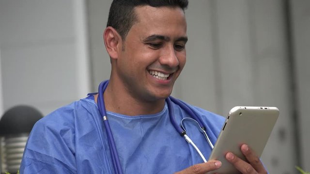Happy Hispanic Male Surgeon With Tablet