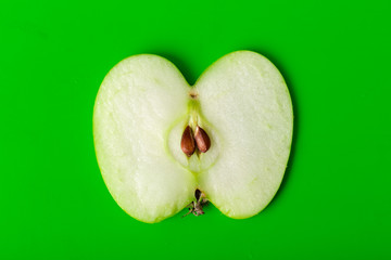 green apple sliced isolated on green background