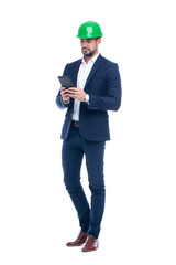 Young professional caucasian engineer in formal wear using digital tablet isolated