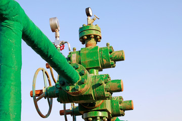 green insulation pipes and red valve, workplaces in the field