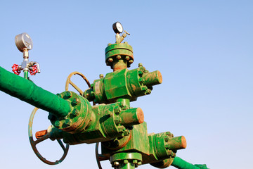green insulation pipes and red valve, workplaces in the field