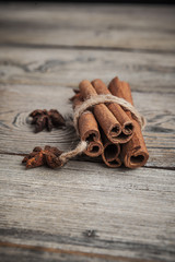 Cinnamon sticks on wooden background.