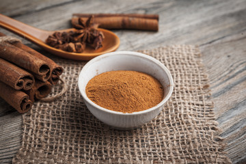 Cinnamon sticks on wooden background.